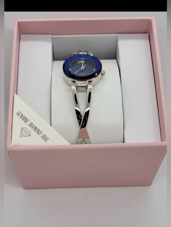 Folio diamond watch with  a blue faceted dial and a silver-tone bangle bracelet